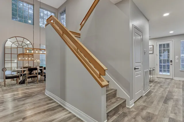 a view of an entryway with wooden floor windows and a livingroom
