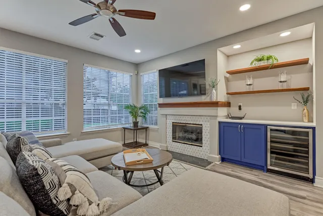 a living room with furniture a flat screen tv and a fireplace