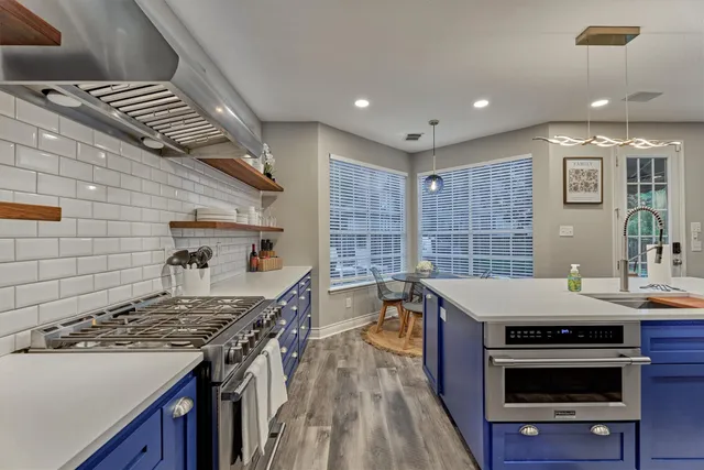 a kitchen with a stove and cabinets
