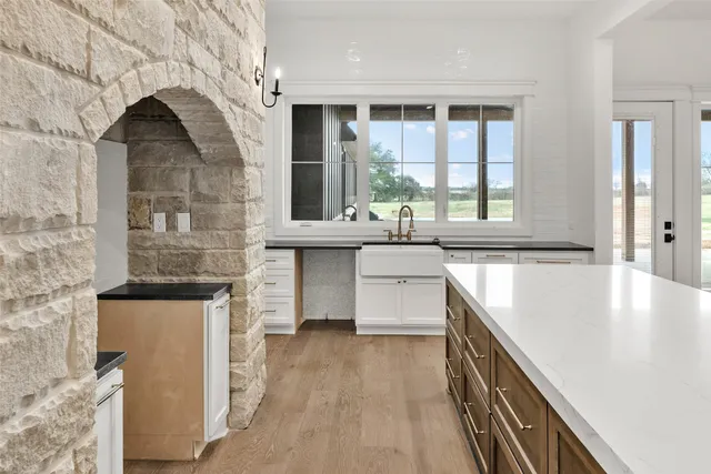 a kitchen with a sink stove and cabinets