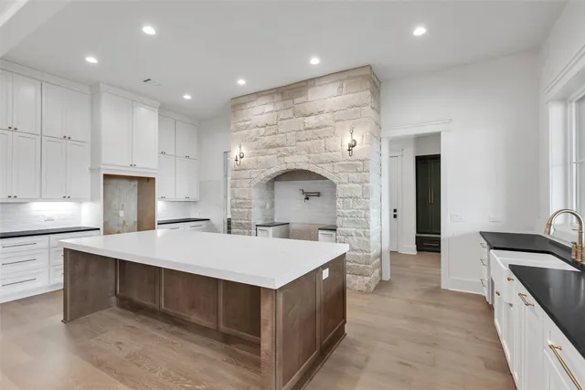 a large kitchen with kitchen island a sink stainless steel appliances and cabinets