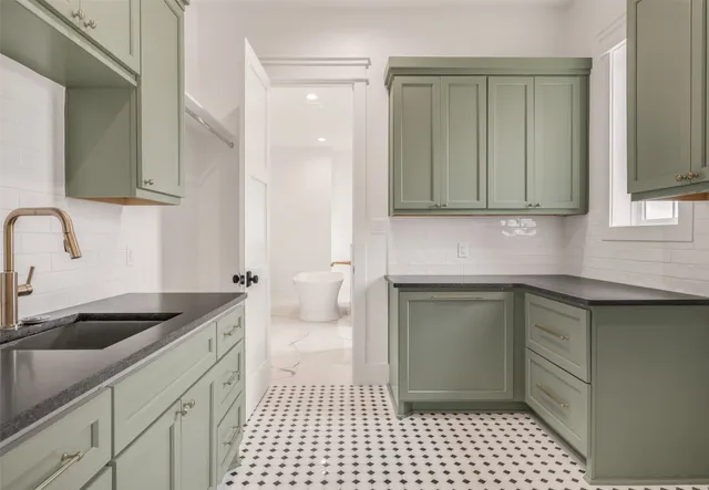 a kitchen with a sink and cabinets