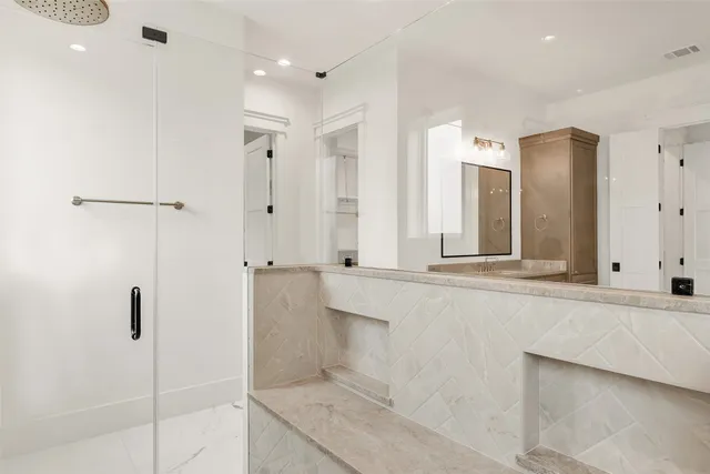 a bathroom with a tub a sink and mirror