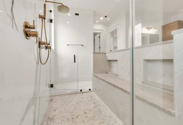 a bathroom with a glass shower door