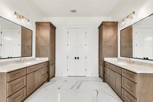 a spacious bathroom with a granite countertop double vanity sink mirror and