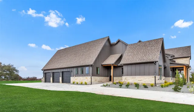 a view of a house with a yard and potted plants