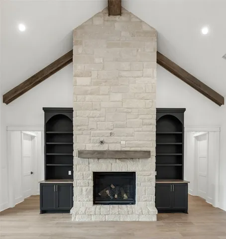 a living room with a fireplace and a walk in closet