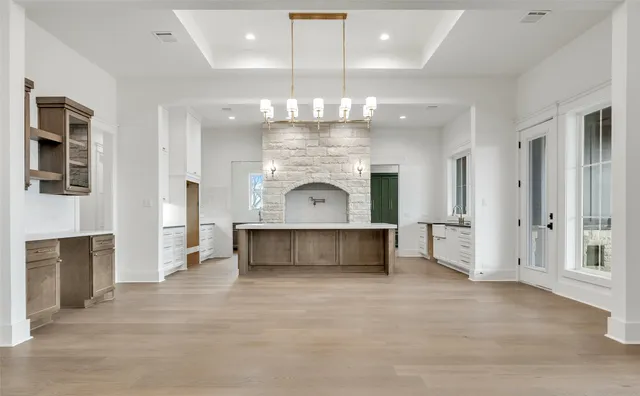an entryway with fireplace and chandelier