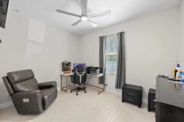 a view of a workspace with furniture and a window