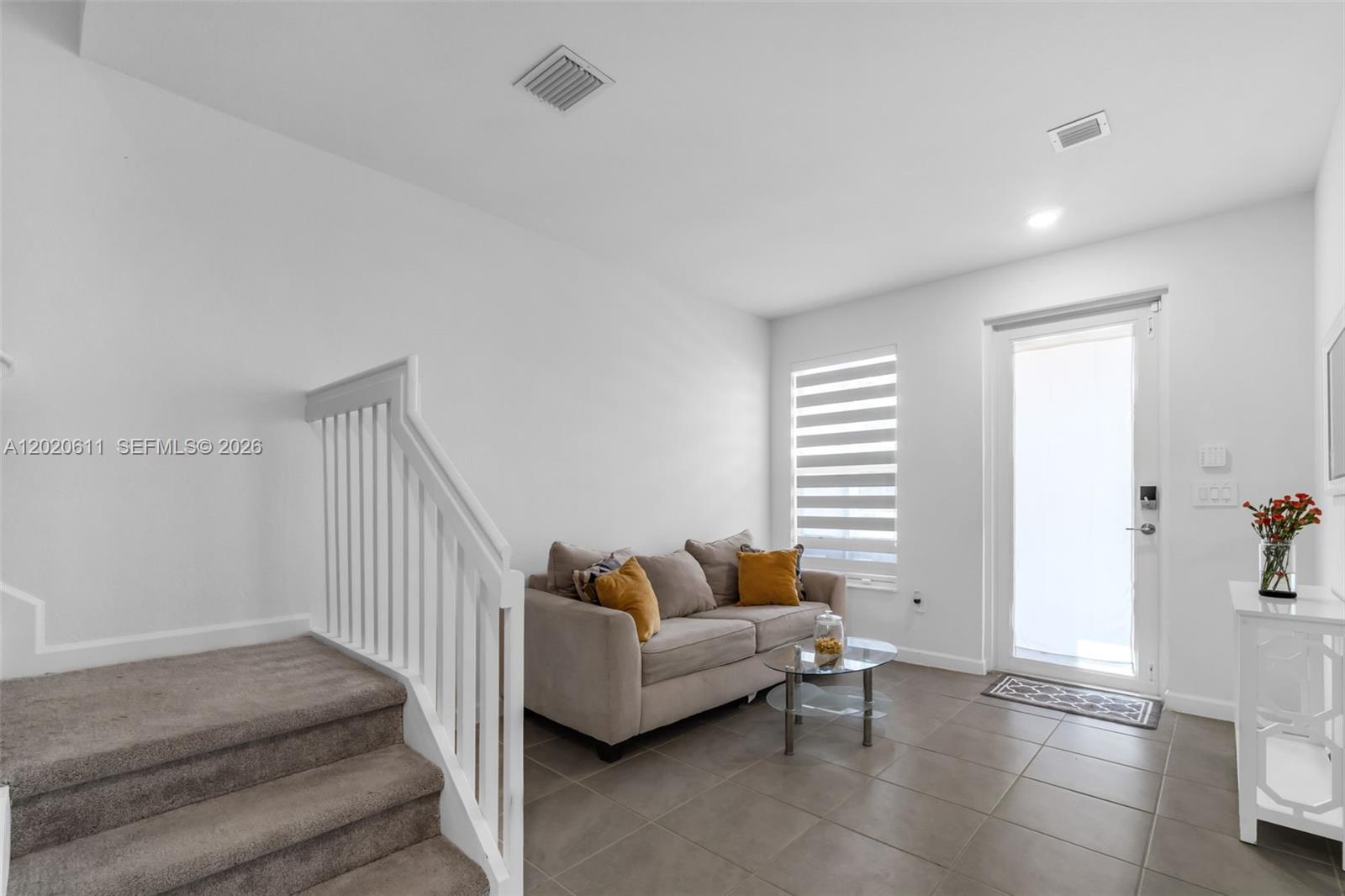 26455 Southwest 148th Avenue Homestead, FL 33032 - Photo 5 of 35 a living room with furniture and stairs