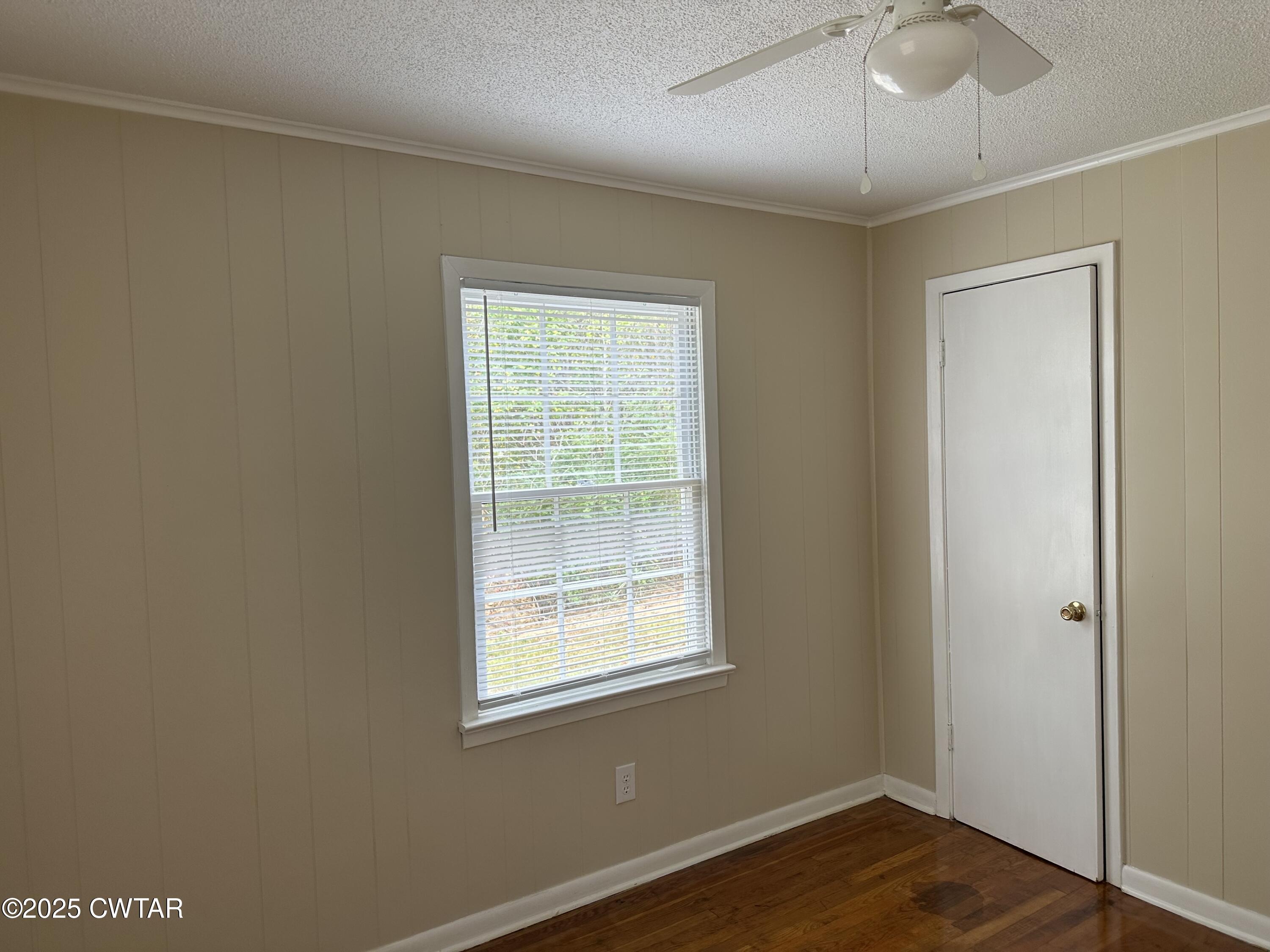 2400 Peddy Vestal Loop Henderson, TN 38340 - Photo 18 of 40 a view of a room with wooden floor and chandelier fan