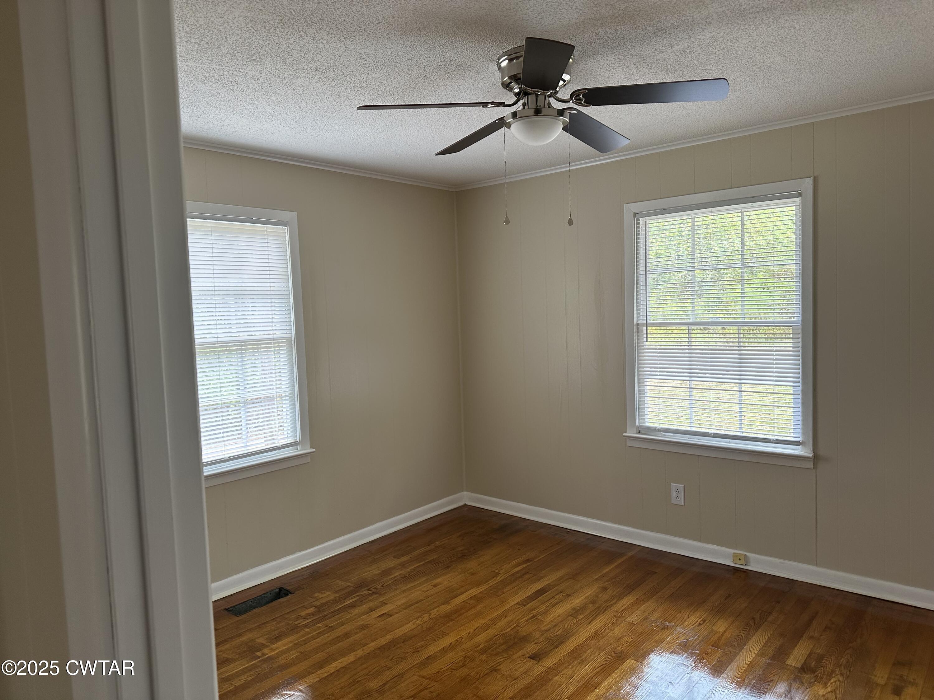 2400 Peddy Vestal Loop Henderson, TN 38340 - Photo 20 of 40 a view of empty room with wooden floor and fan