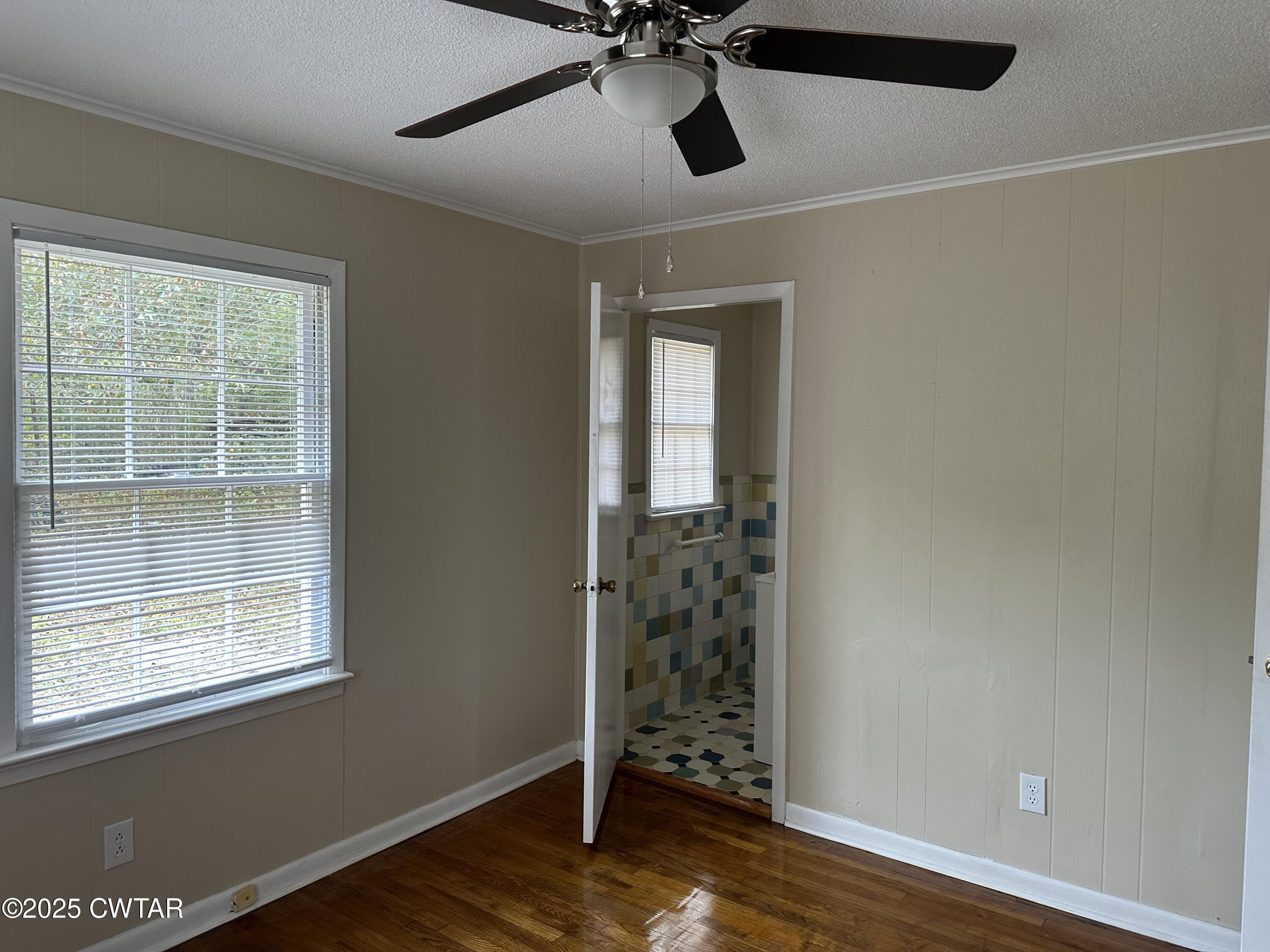 2400 Peddy Vestal Loop Henderson, TN 38340 - Photo 21 of 40 a view of empty room with wooden floor and fan