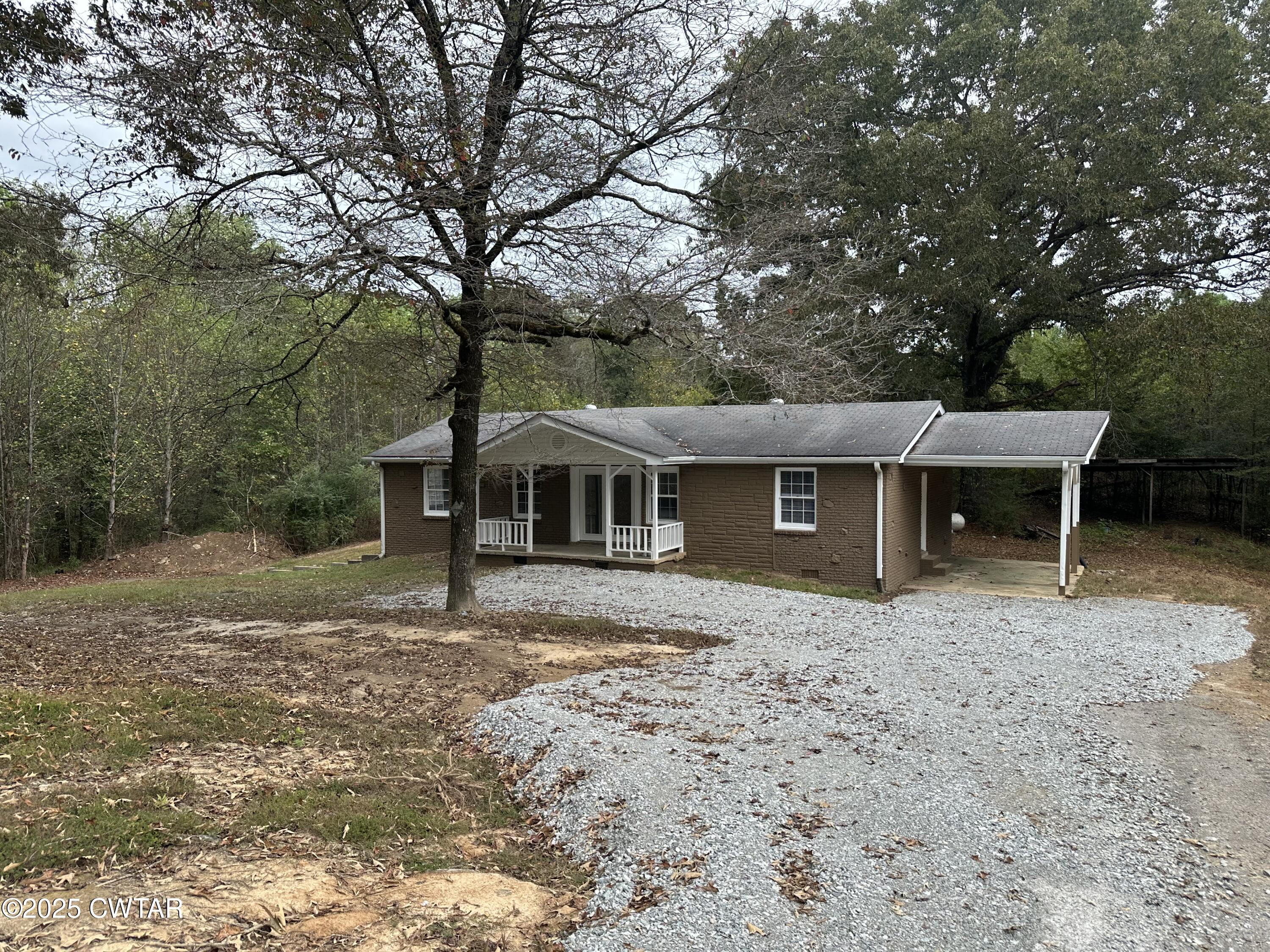 2400 Peddy Vestal Loop Henderson, TN 38340 - Photo 27 of 40 a front view of a house with a garden