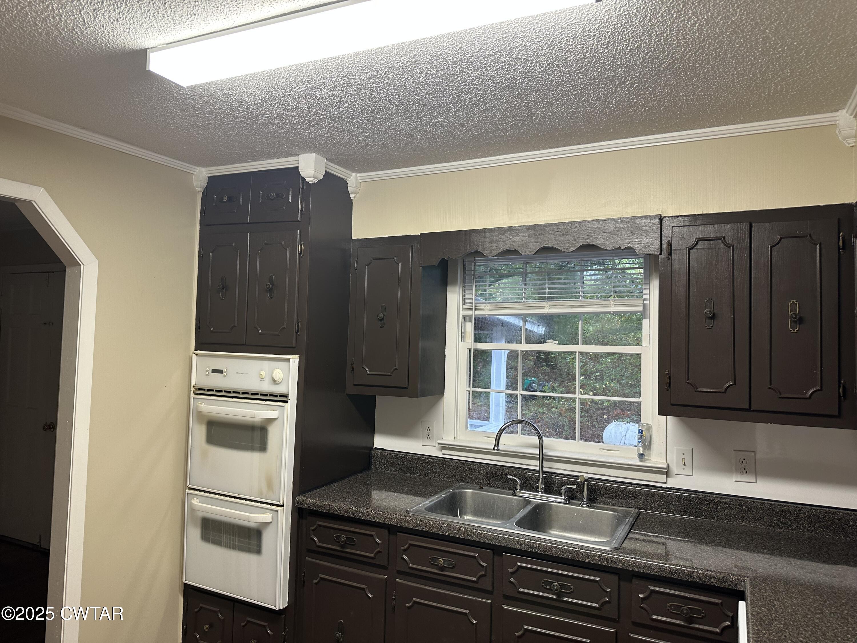 2400 Peddy Vestal Loop Henderson, TN 38340 - Photo 3 of 40 a kitchen with a sink and a refrigerator