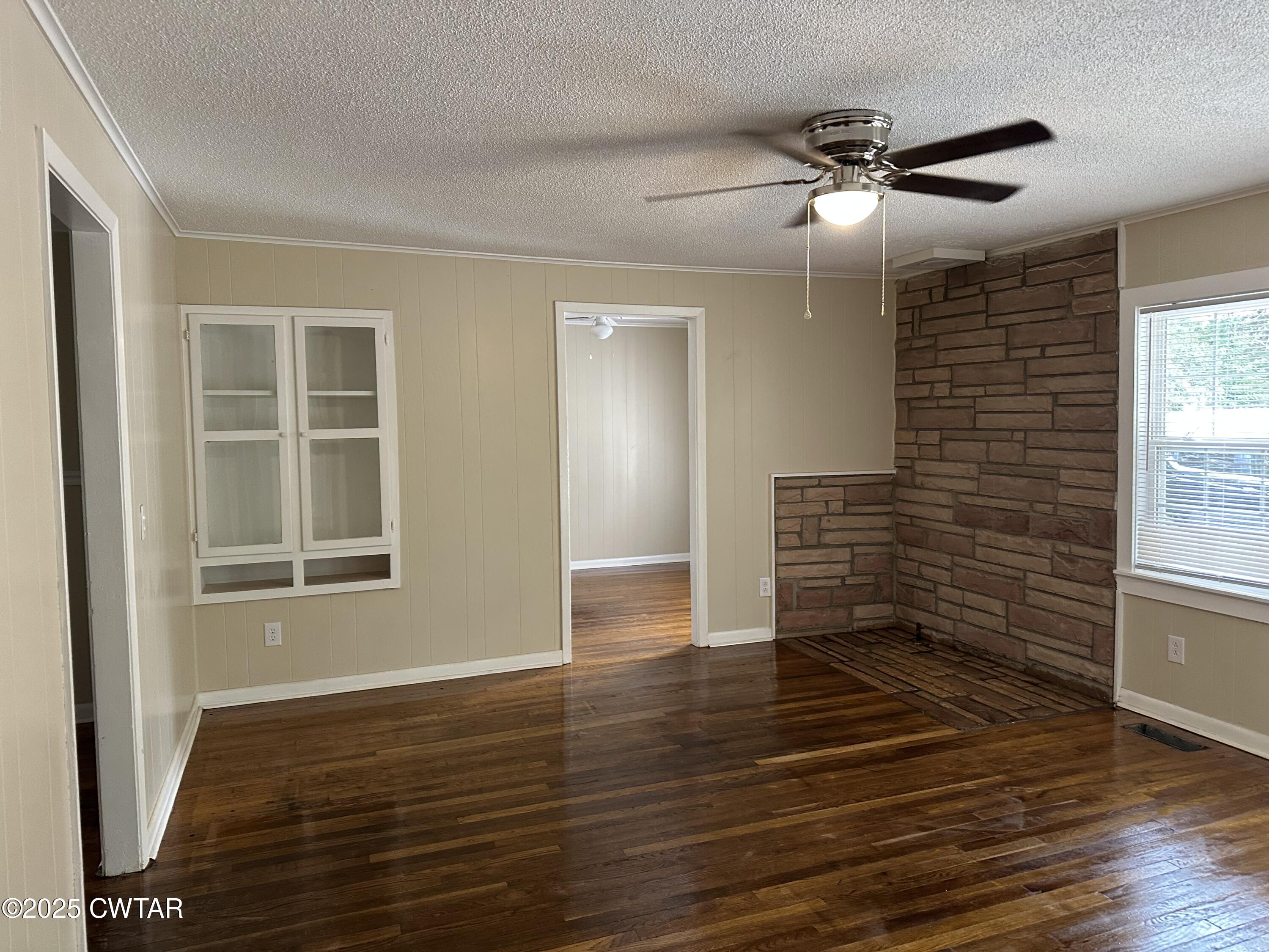 2400 Peddy Vestal Loop Henderson, TN 38340 - Photo 6 of 40 a view of an empty room with wooden floor and a window