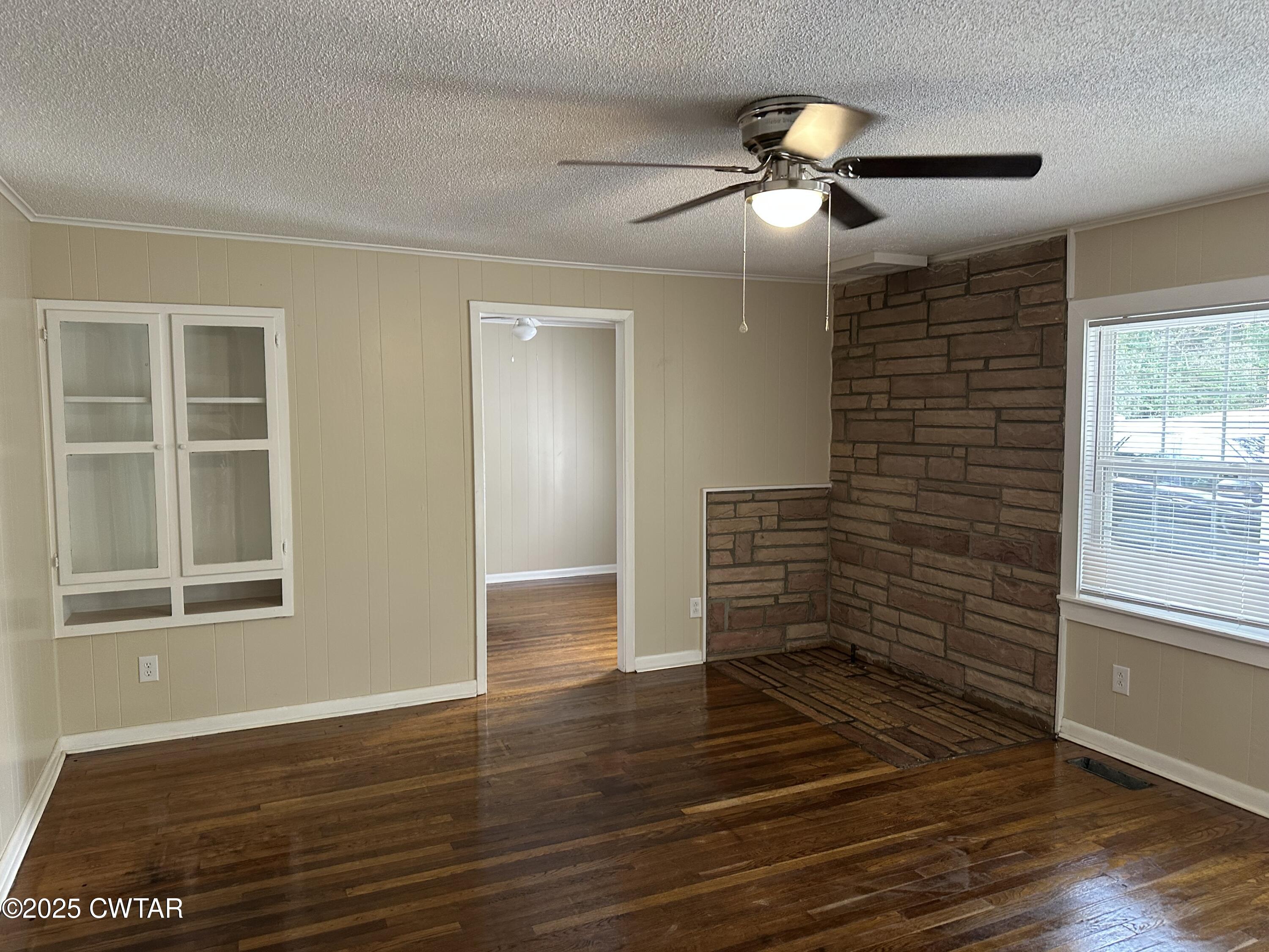 2400 Peddy Vestal Loop Henderson, TN 38340 - Photo 7 of 40 a view of an empty room with wooden floor and a window