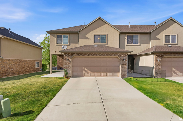 1165 West 100 South Springville, UT 84663 - Photo 16 of 28 Traditional home featuring stucco siding, a front yard, driveway, and brick siding