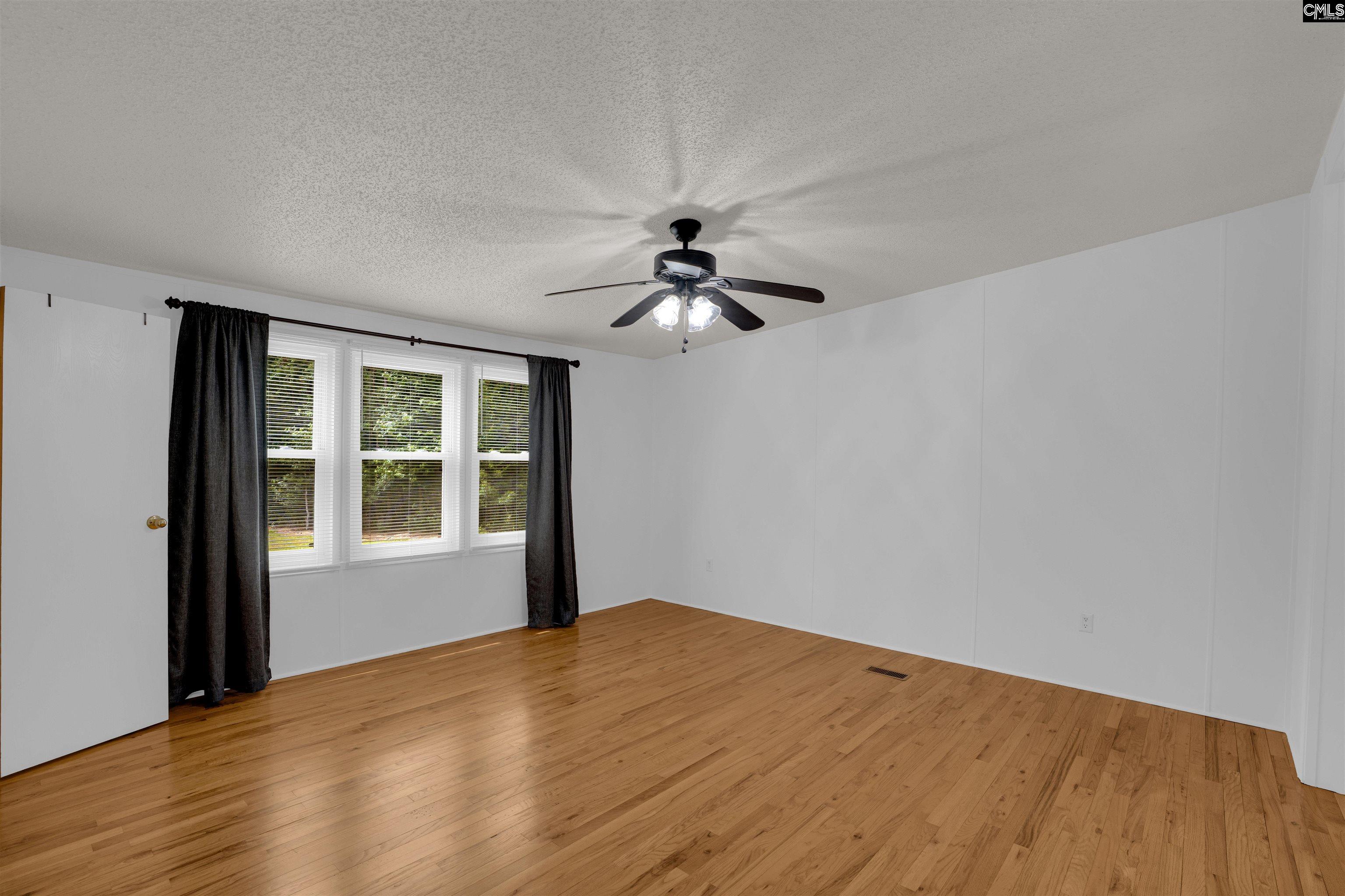 304 Cooper Road Blythewood, SC 29016 - Photo 15 of 29 a view of empty room with wooden floor and fan