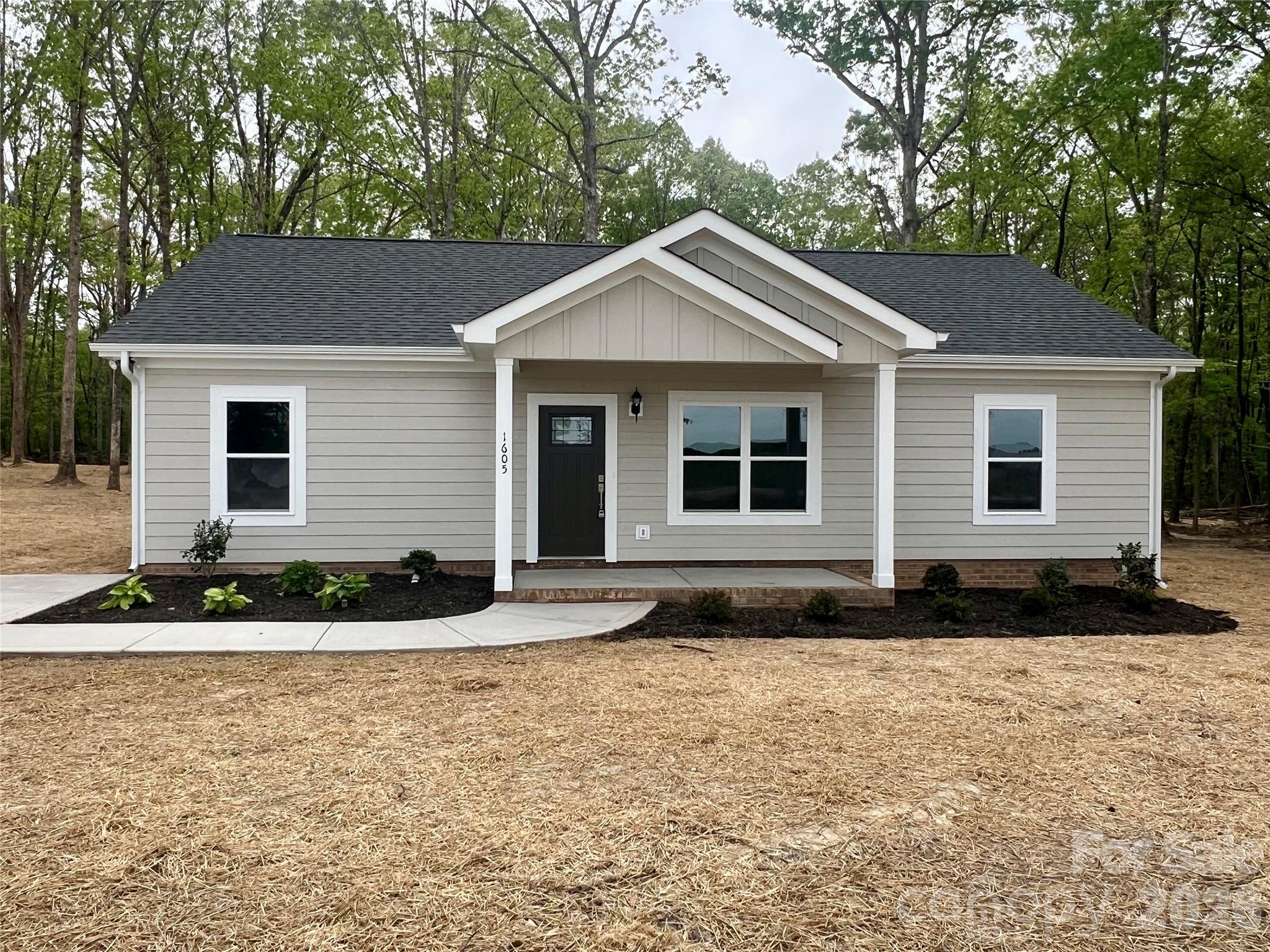 1605 North Sutherland Avenue Monroe, NC 28110 - Photo 1 of 1 a front view of a house with garden