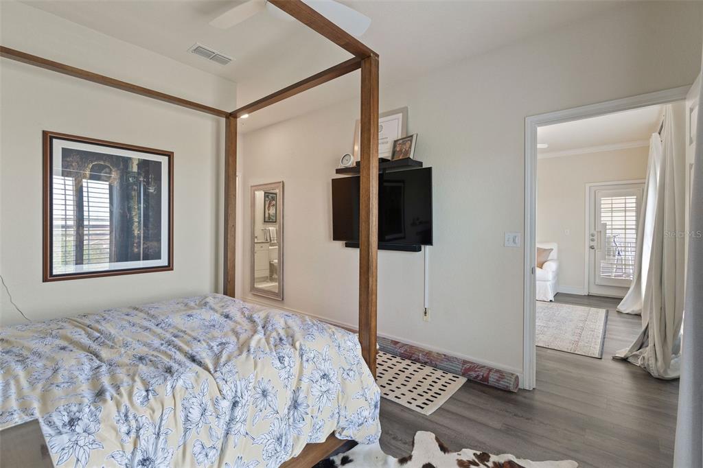 1216 South Missouri Avenue, Unit 419 Clearwater, FL 33756 - Photo 11 of 22 a bedroom with a bed and a view of bathroom