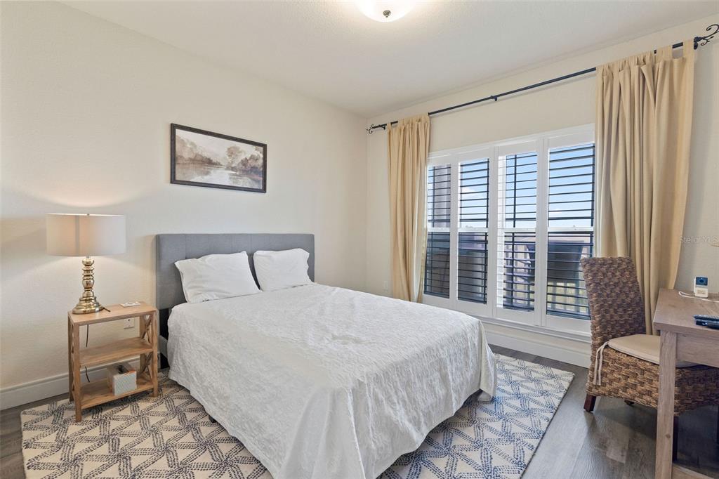 1216 South Missouri Avenue, Unit 419 Clearwater, FL 33756 - Photo 14 of 22 a bedroom with a large bed and a window