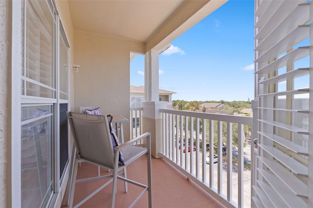 1216 South Missouri Avenue, Unit 419 Clearwater, FL 33756 - Photo 18 of 22 a view of a balcony with chair and table