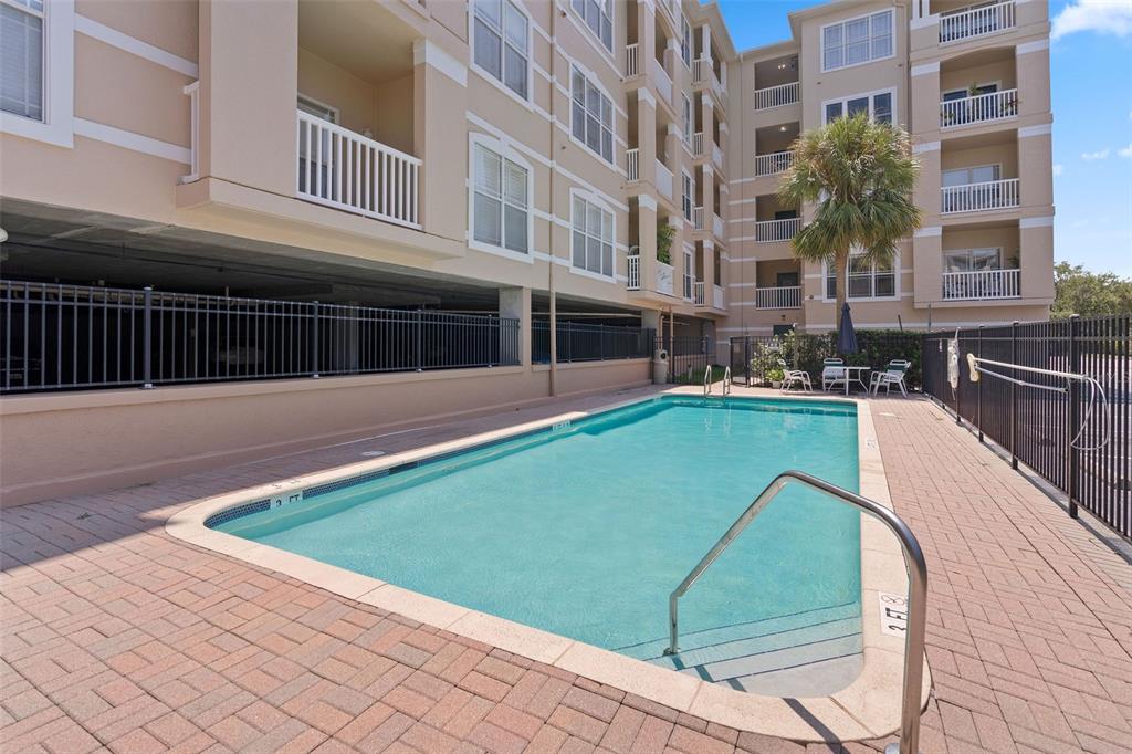 1216 South Missouri Avenue, Unit 419 Clearwater, FL 33756 - Photo 21 of 22 a view of a swimming pool with a lounge chairs