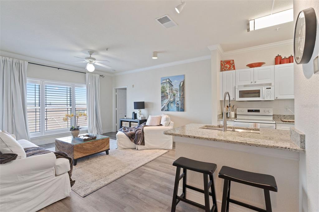 1216 South Missouri Avenue, Unit 419 Clearwater, FL 33756 - Photo 4 of 22 a living room with furniture and a table