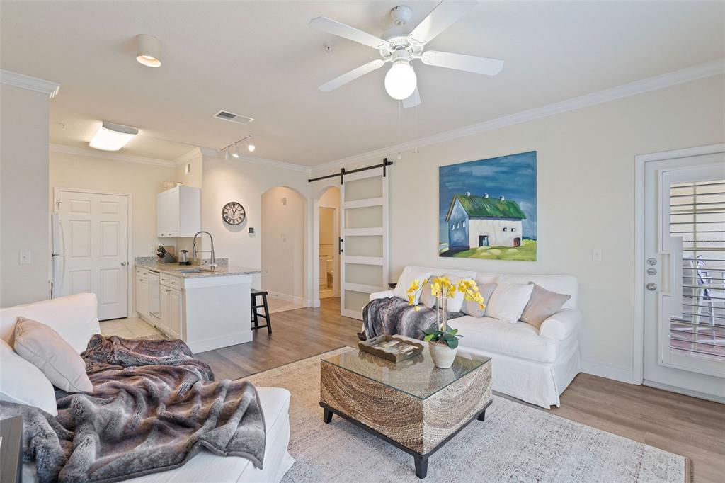 1216 South Missouri Avenue, Unit 419 Clearwater, FL 33756 - Photo 5 of 22 a living room with furniture and a large window