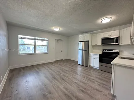 a kitchen with stainless steel appliances a refrigerator and a stove top oven