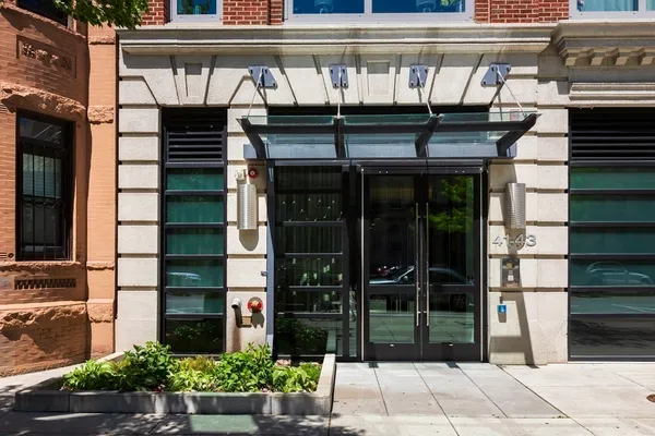 a front view of a building with glass windows and door
