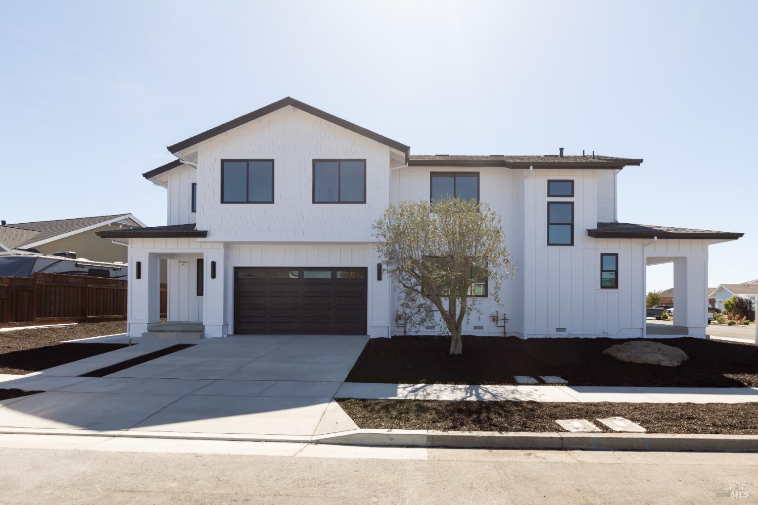 a view of a house with a yard and a garage