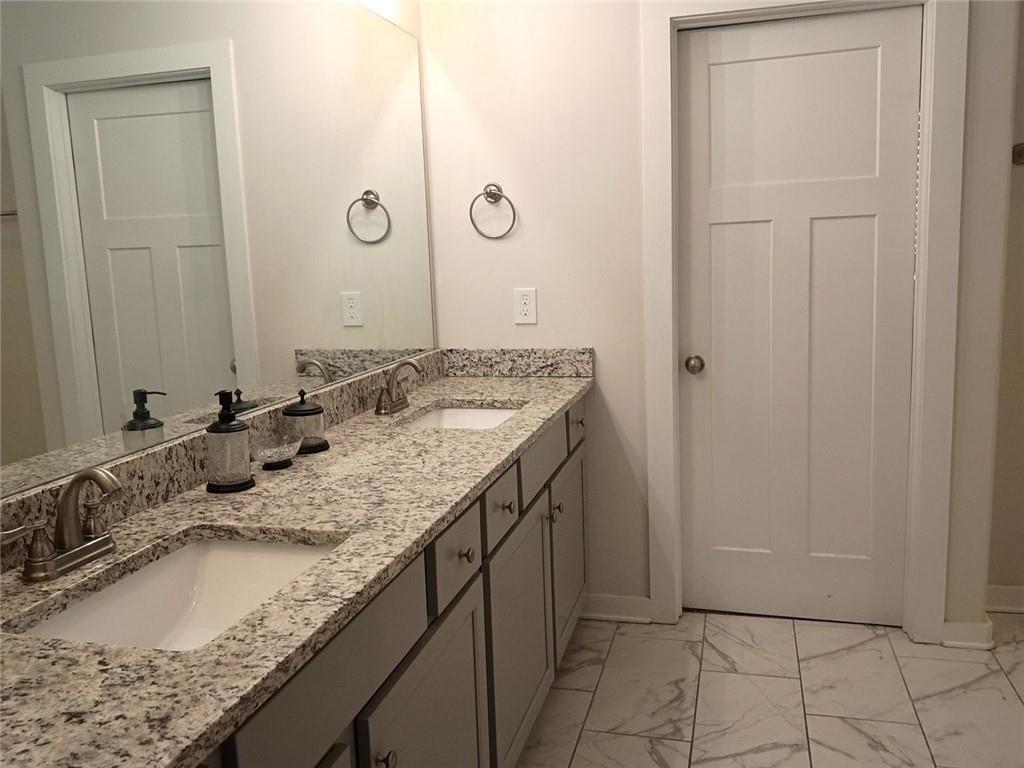 807 Ridgeview Court Hampton, GA 30228 - Photo 41 of 69 a bathroom with a granite countertop sink and a mirror