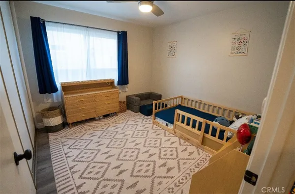 a bedroom with furniture and a window