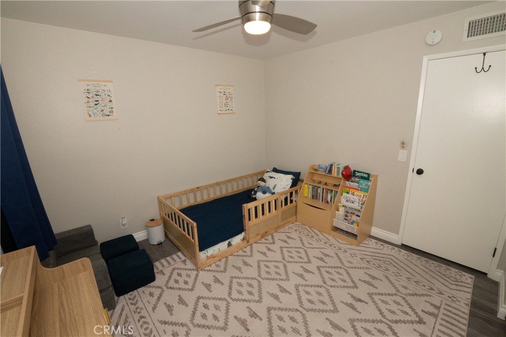 27626 Saffron Lane Saugus, CA 91350 - Photo 12 of 24 a bedroom with a bed and a chandelier