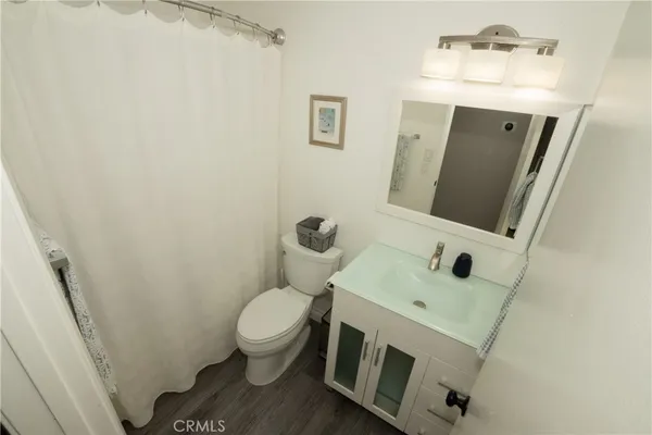 a bathroom with a sink toilet and mirror