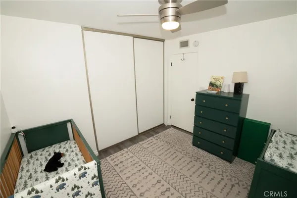 a bedroom with a bed and a dresser in it