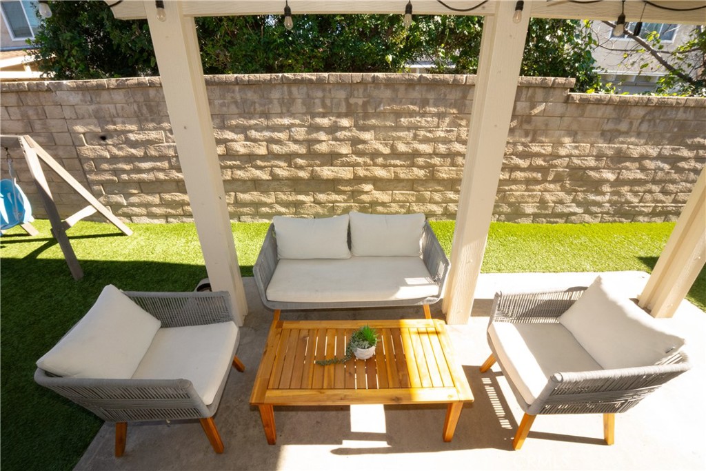 27626 Saffron Lane Saugus, CA 91350 - Photo 16 of 24 a view of a patio with table and chairs and wooden floor
