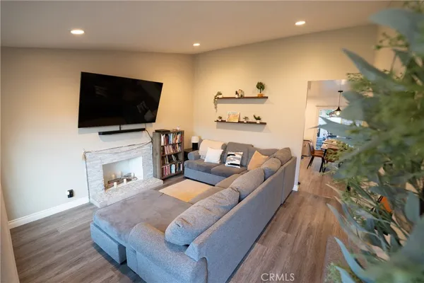 a living room with fireplace furniture and a flat screen tv