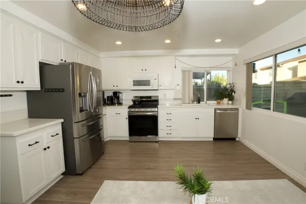 a kitchen with stainless steel appliances a refrigerator sink and cabinets