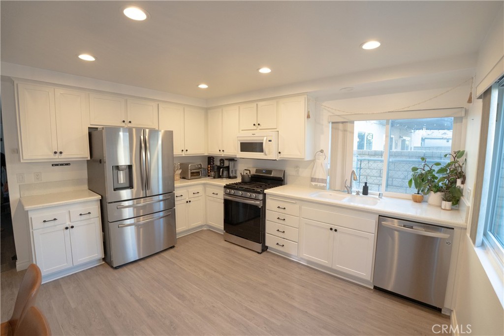 27626 Saffron Lane Saugus, CA 91350 - Photo 6 of 24 a kitchen with a refrigerator stove and sink