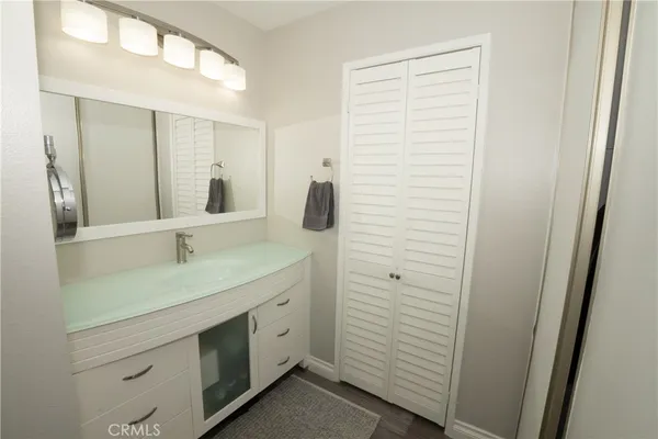 a bathroom with a shower sink and mirror