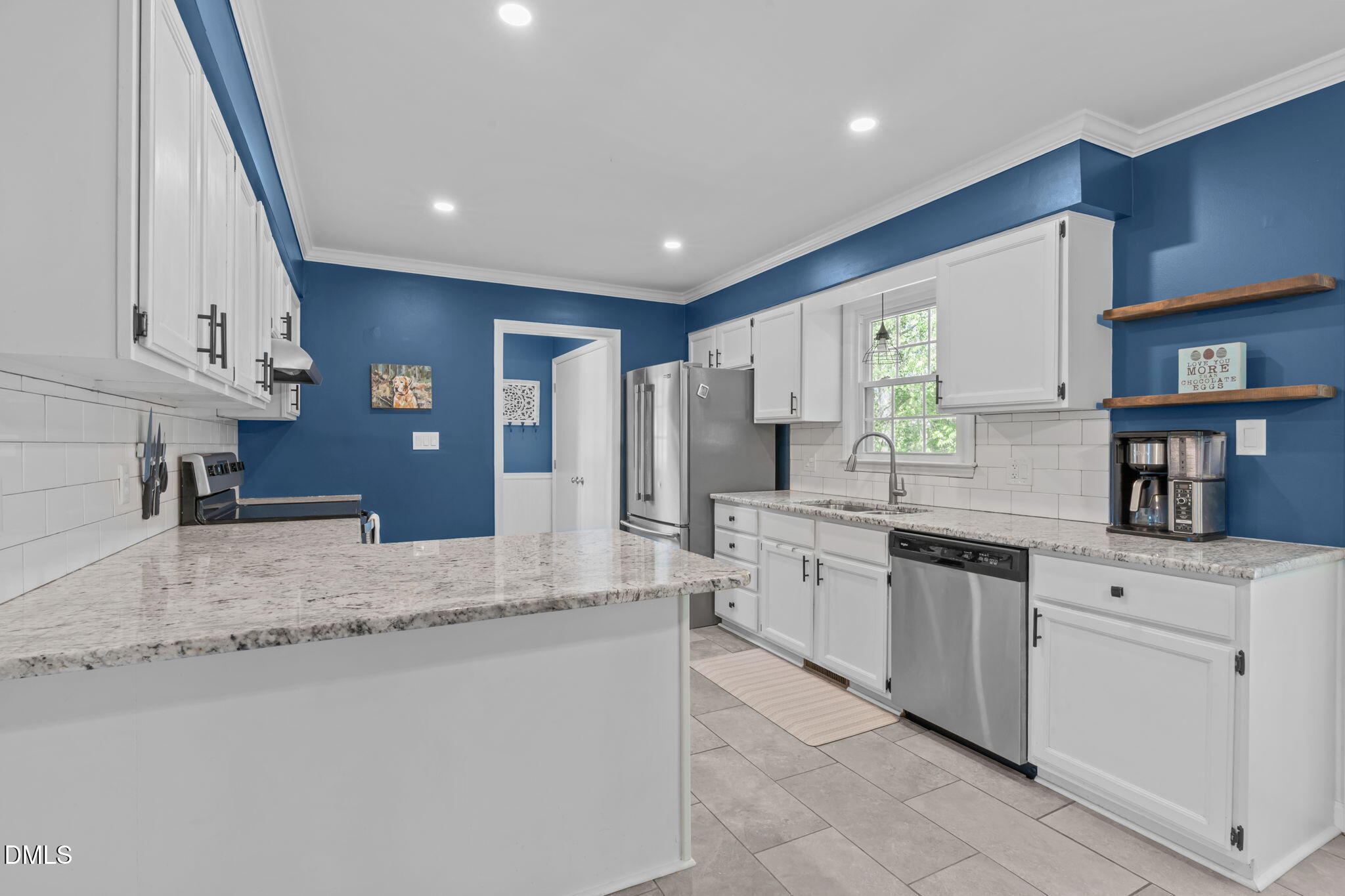 717 Habersham Place Raleigh, NC 27610 - Photo 12 of 59 a kitchen with stainless steel appliances granite countertop a stove a sink and a refrigerator