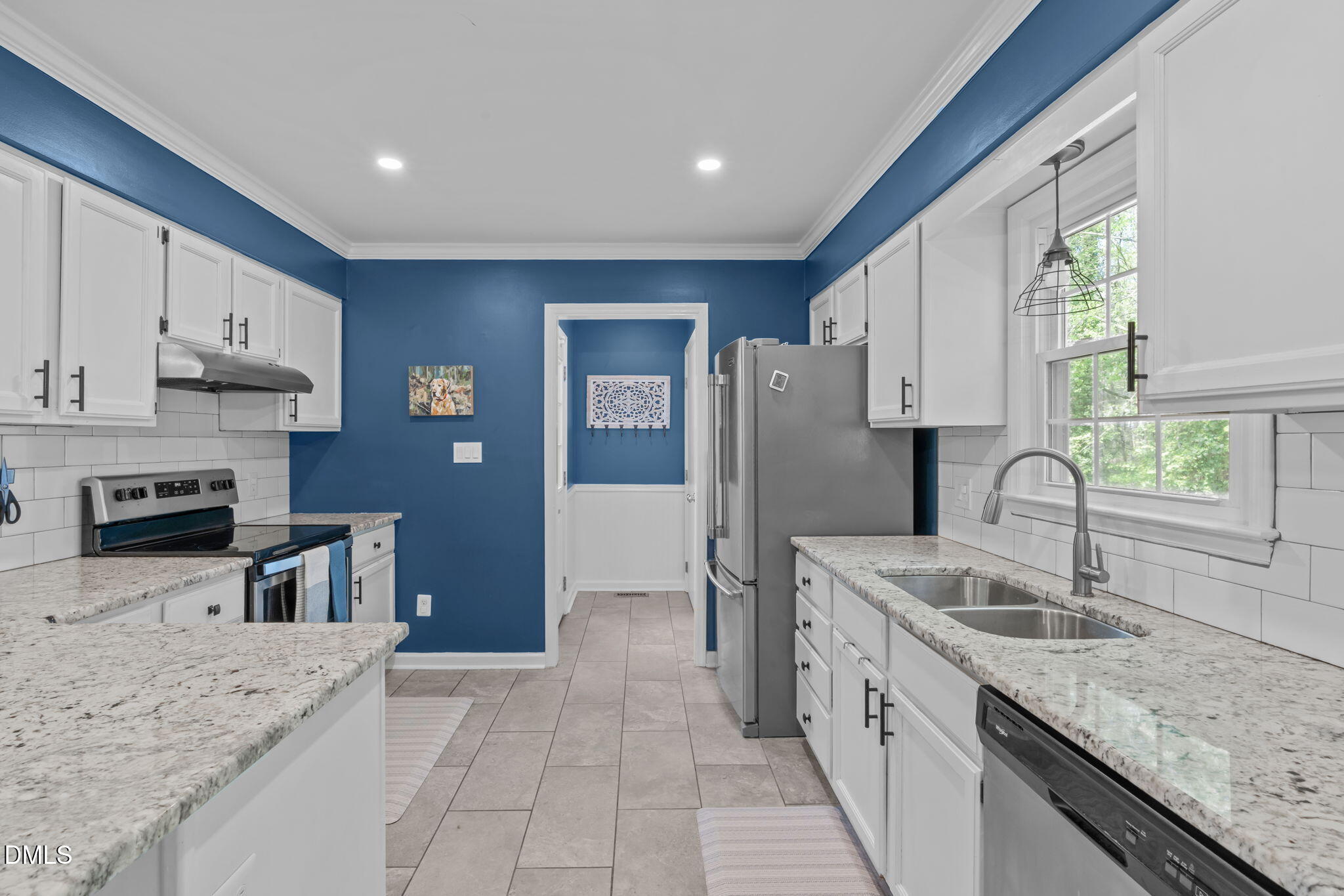 717 Habersham Place Raleigh, NC 27610 - Photo 13 of 59 a kitchen with stainless steel appliances granite countertop a sink refrigerator stove and microwave