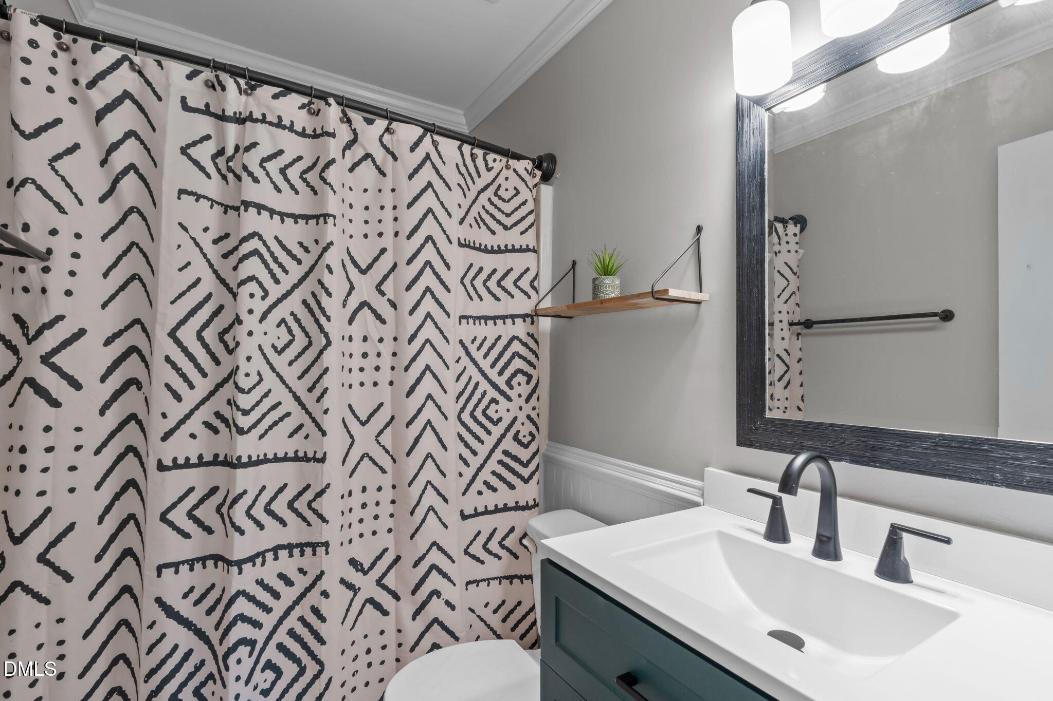 717 Habersham Place Raleigh, NC 27610 - Photo 19 of 59 a bathroom with a sink and a mirror
