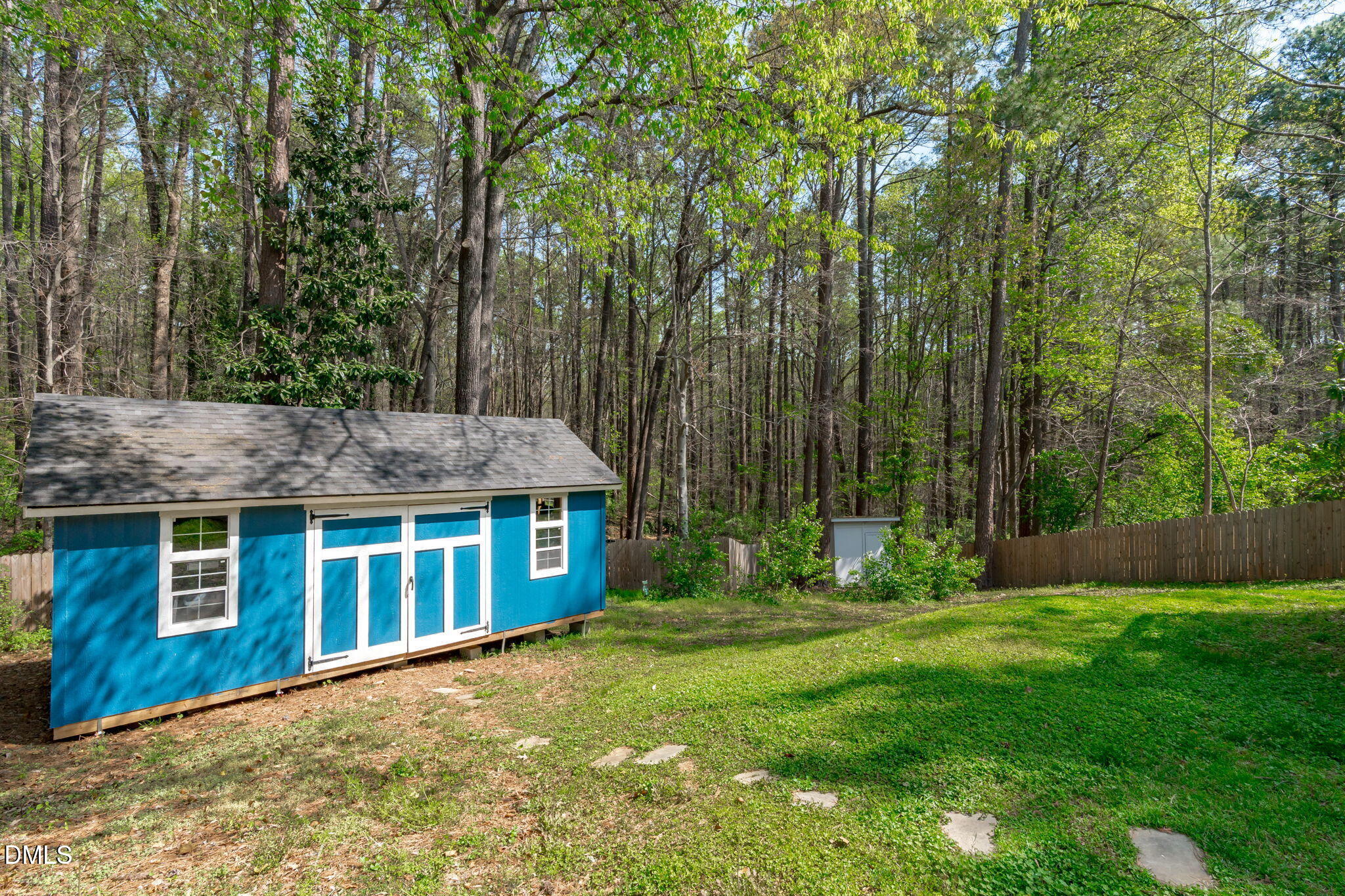 717 Habersham Place Raleigh, NC 27610 - Photo 39 of 59 a backyard of a house with large trees and plants