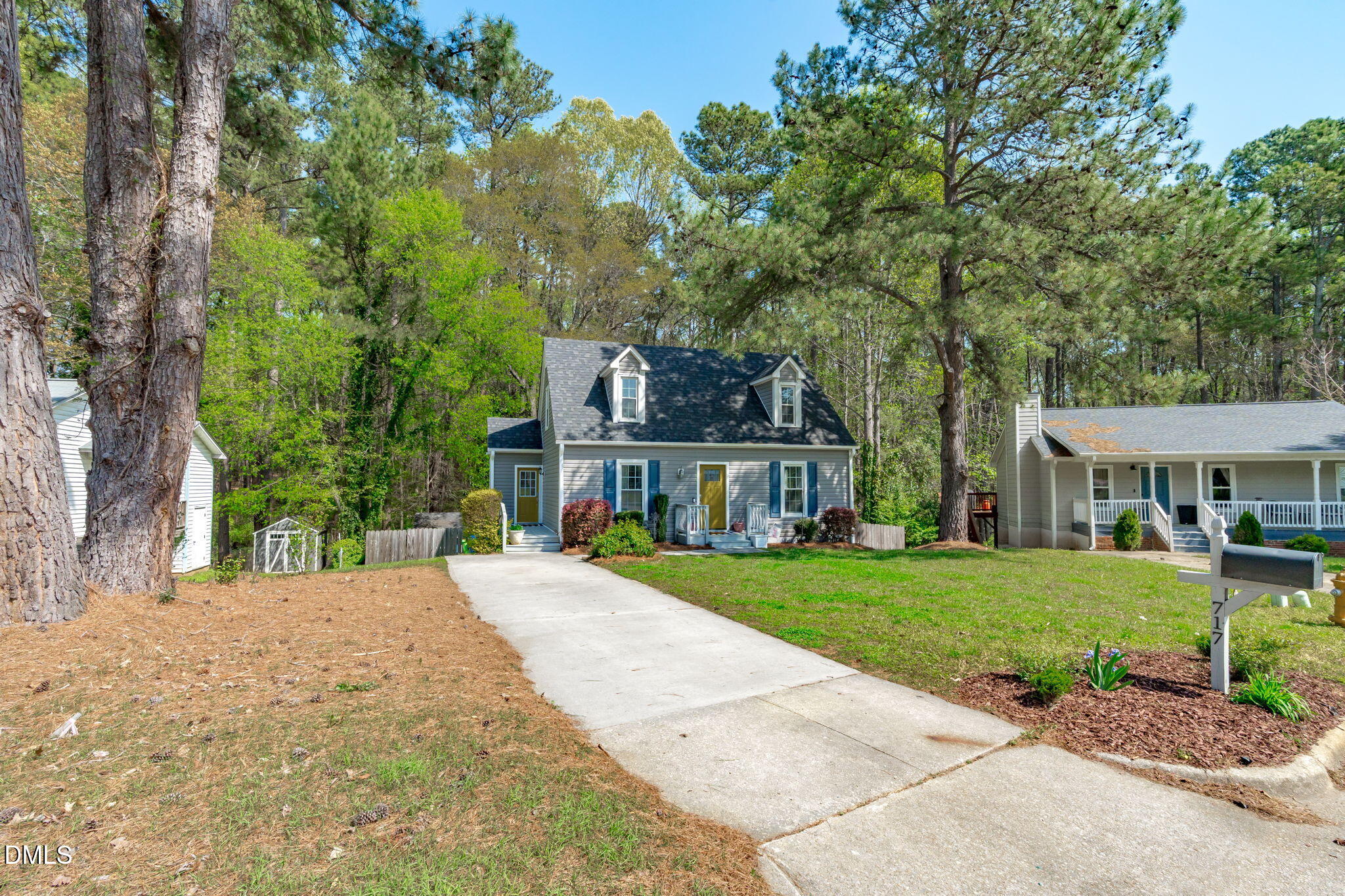 717 Habersham Place Raleigh, NC 27610 - Photo 44 of 59 a front view of a house with a garden and trees