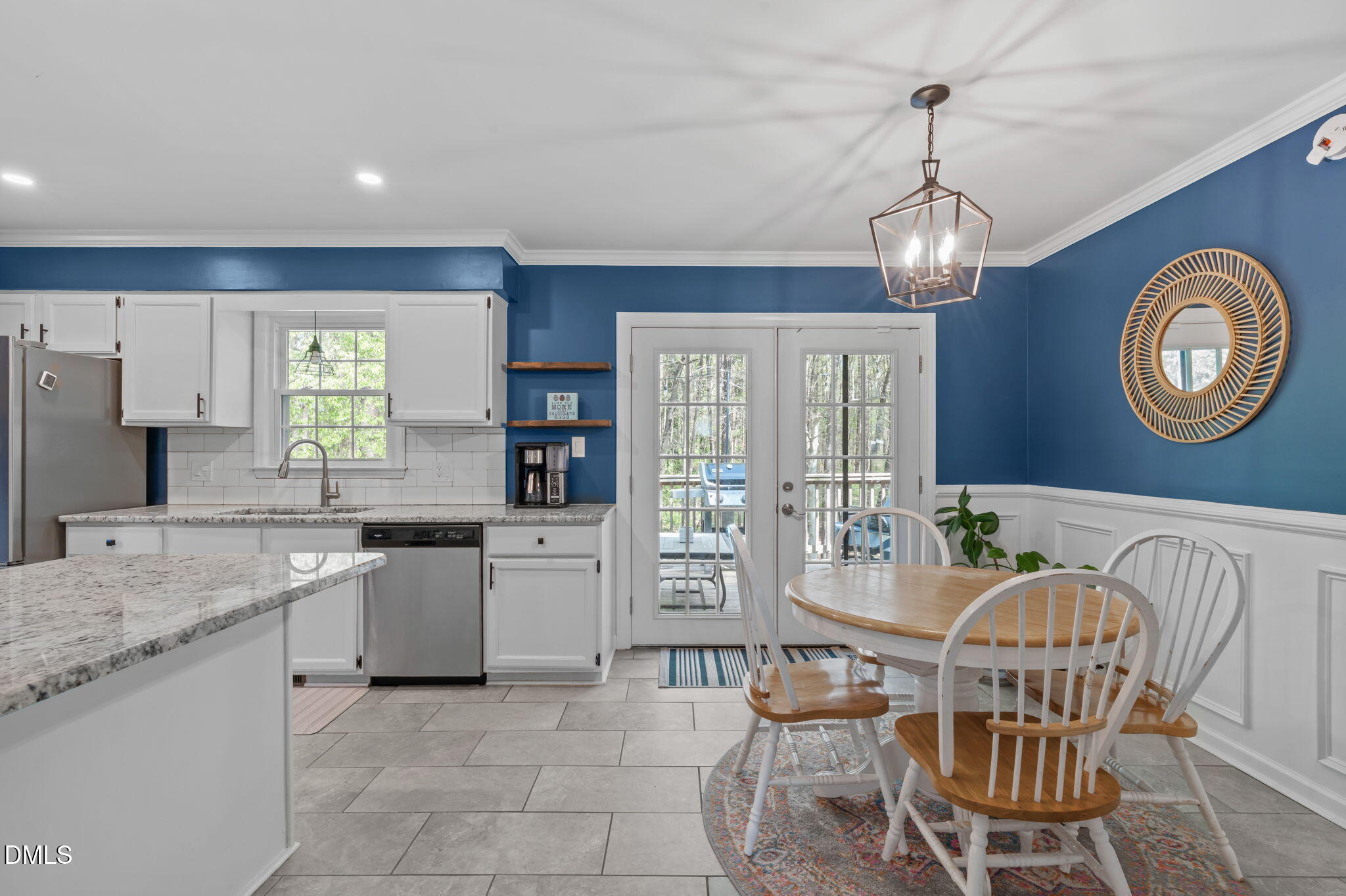 717 Habersham Place Raleigh, NC 27610 - Photo 8 of 59 a kitchen with stainless steel appliances granite countertop a kitchen island a stove a table and chairs