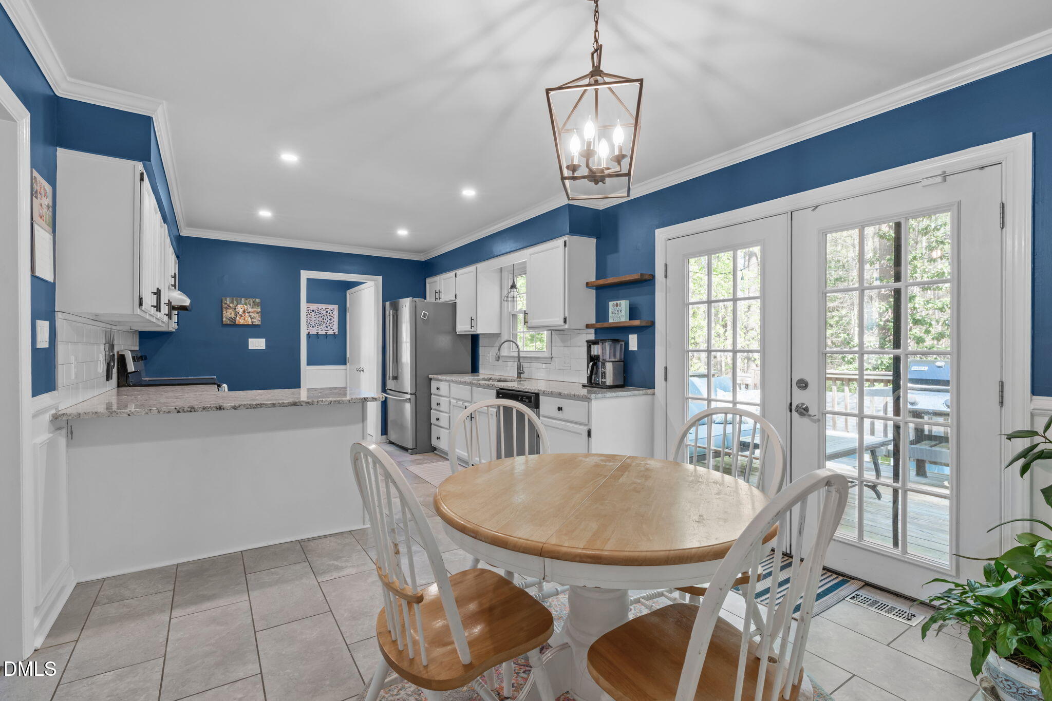 717 Habersham Place Raleigh, NC 27610 - Photo 10 of 59 a kitchen with sink refrigerator dining table and chairs